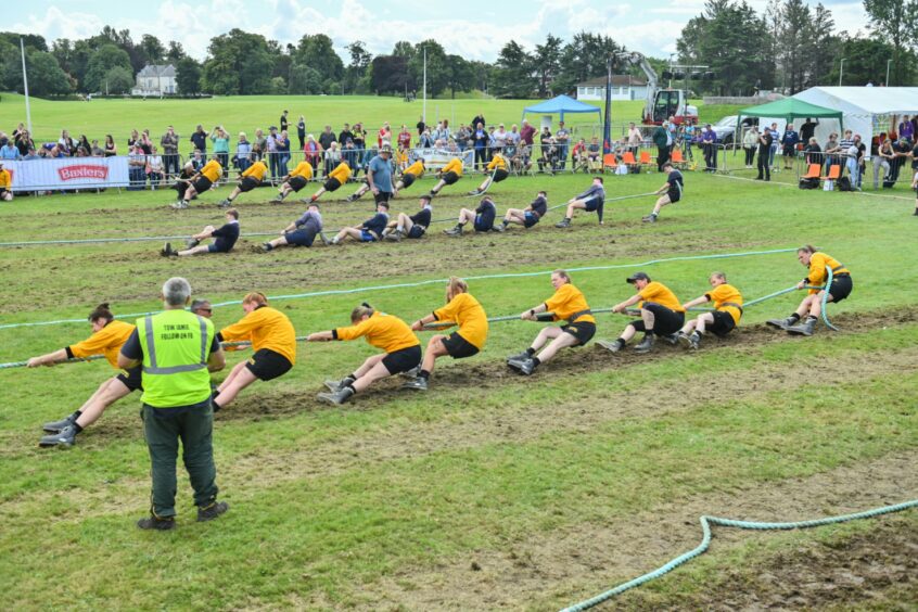 Teams competing in the tug of war.