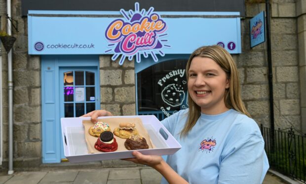 Amanda Charles outside her new shop with some of her cookies