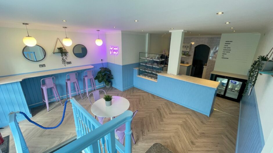 The interior of Cookie Cults in Aberdeen, with cream and blue walls, purple chairs and wooden countertops
