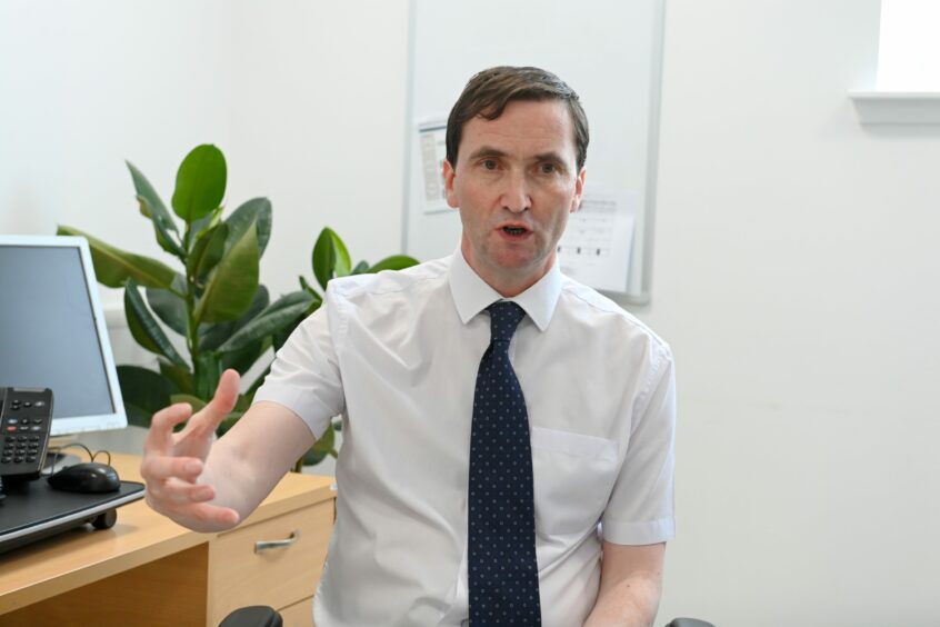 Dr Chris Provan at his desk