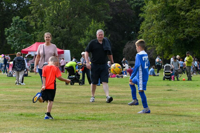 A family kicking a ball around