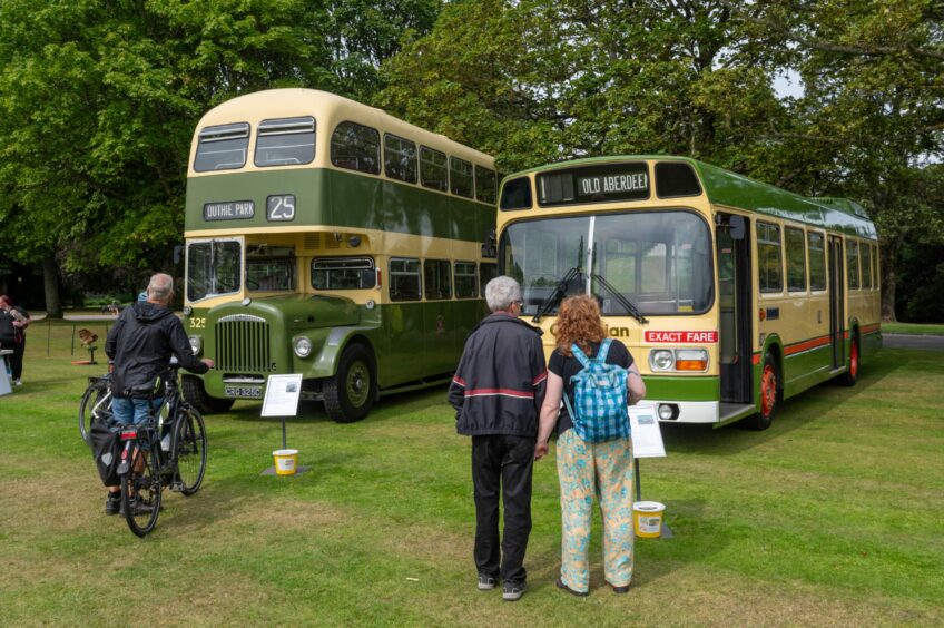 Visitors admiring some vintage buses brought in for the event. 