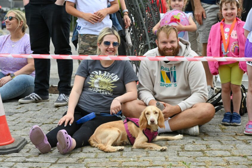 A couple with their pooch watching the race. 