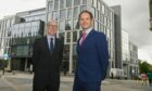 Phil Gordon and Brian Archer, of CGI, outside the firm's new Aberdeen office in Marischal Square.