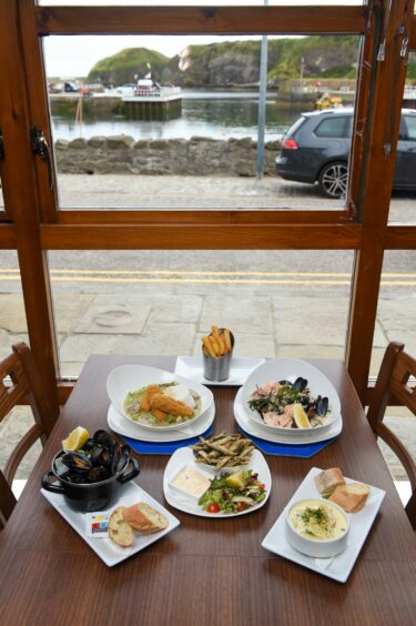 Tablespread at The Captain's Table with views of Stonehaven harbour