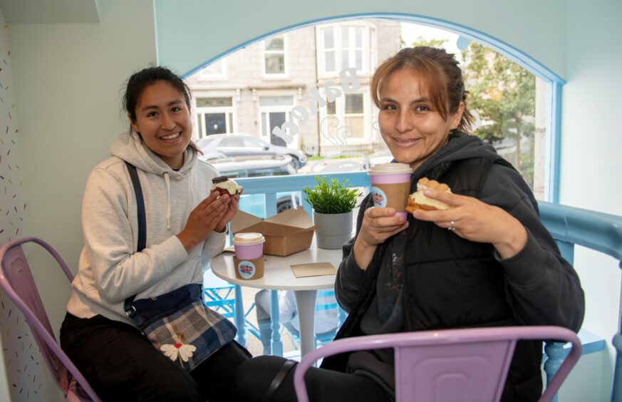 Customers sitting at a table in the Cookie Cult shop in Aberdeen