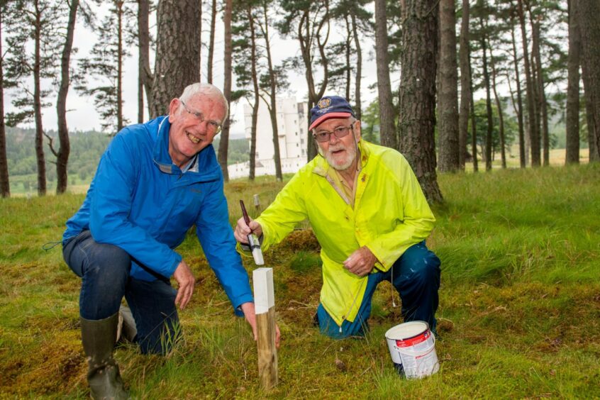 Volunteers Dave Chandler and Neil Bain marking out new pathways in Braemar Castle's woodland as part of the renovation.