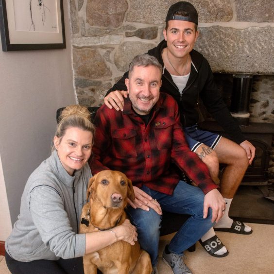 Ashley and Kevin Wilson with their son Lewis and dog Bono at their home in Aberdeen.