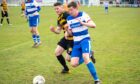 Dyce's Darren Reid on the ball with Stonehaven's Findlay Masson in pursuit. 
Image: Kami Thomson/DC Thomson
