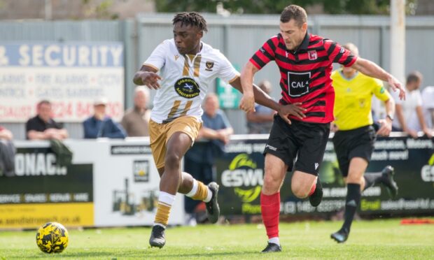 Huntly's Michael Dangana, left, tries to get away from Paul Coutts of Inverurie Locos. Pictures by Kami Thomson/DCT Media