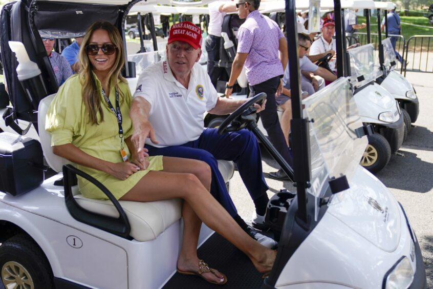 Donald Trump driving a golf buggy at his golf course in Aberdeen.