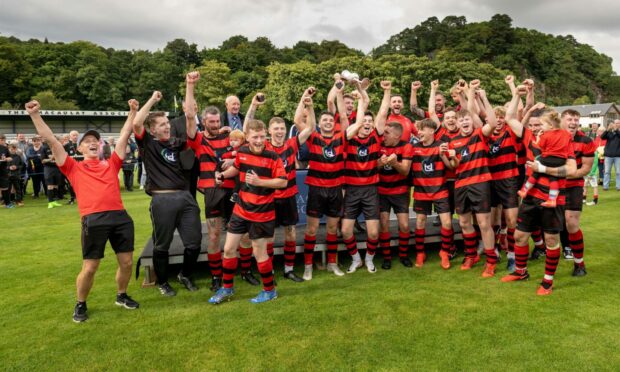 The Oban Camanachd team celebrate lifting the 2023 Artemis MacAulay Cup. Image: Neil Paterson.