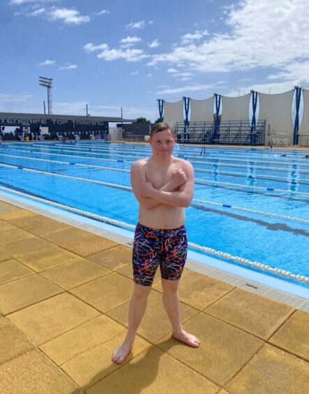 Inverness swimmer Matthew McCreadie, who has down syndrome, at an outdoor pool in swimming trunks