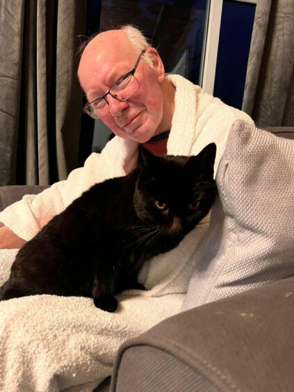 Maurice with one of his cats