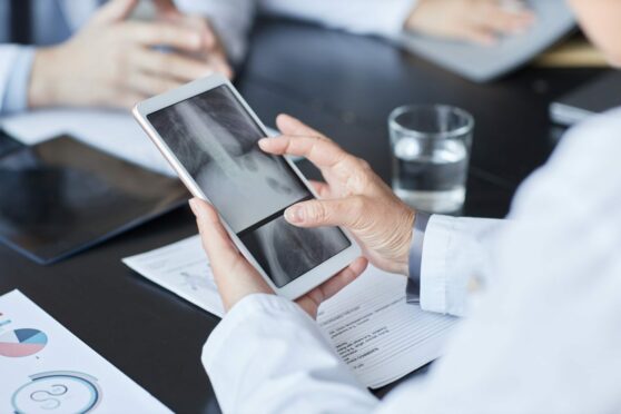Doctor using tablet during consulation