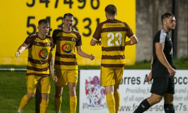 Forres Mechanics goalscorer Shaun Morrison, left, celebrates his first goal against Strathspey Thistle with Calum Frame, centre, and Ethan Cairns