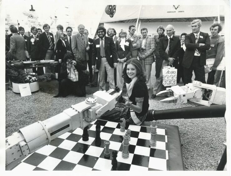 13 September 1977:
Miss Scotland Sandra Bell plays chess with a monster from the deep at the opening day of the Offshore Europe 77 exhibition at Bridge of Don, Aberdeen. Her opponent was Ocean Arms, a deep sea diving bell built by Oceaneering International Inc., of Houston, Texas.