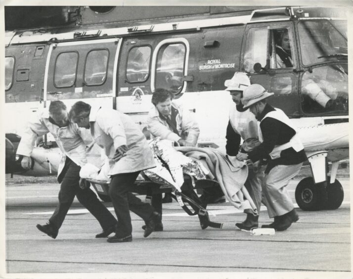 7 July 1988: The scene as a survivor is rushed from the helipad at Aberdeen Royal Infirmary.
