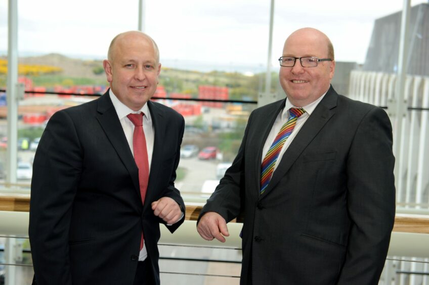 Bob Keiller, then chief executive, welcomes Mr Kemp onto Wood's group board in 2015