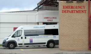 An ambulance vehicle sits outside A&E at Raigmore Hospital.