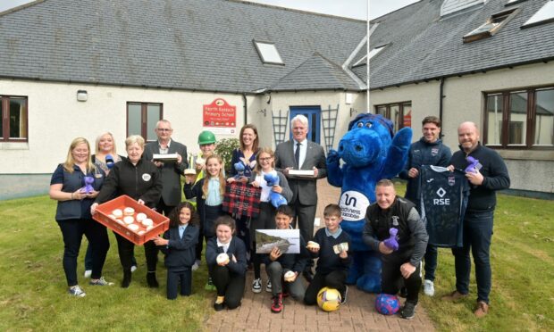 North Kessock Primary School pupils with representatives from Harry Gow, Caley Thistle and Ross Country football clubs, Visit Inverness Loch Ness and Loch Ness by Jacobite who have all donated items for the capsule. 
Image Sandy McCook/DC Thomson