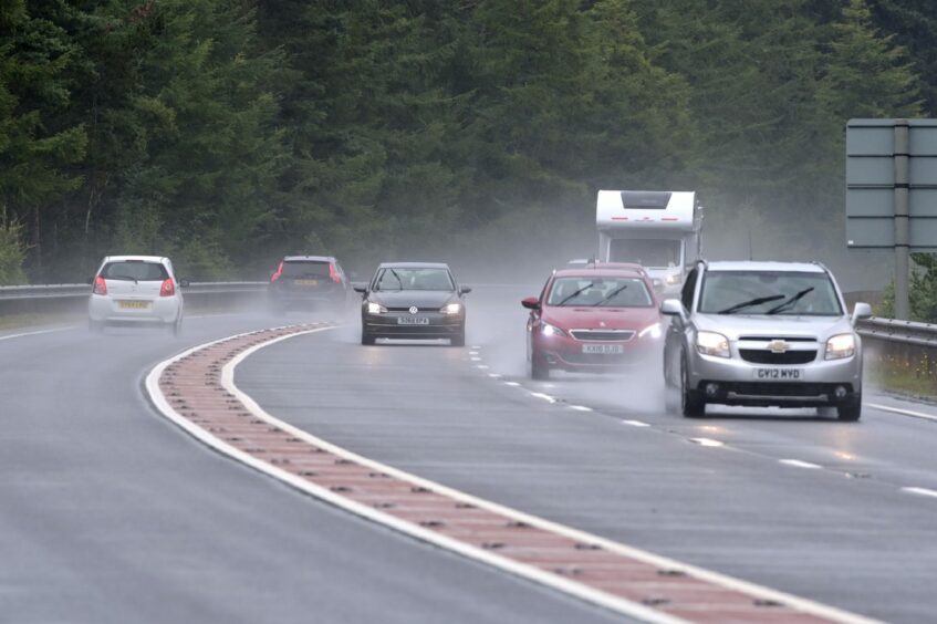 Rain on the A9, with cars driving.