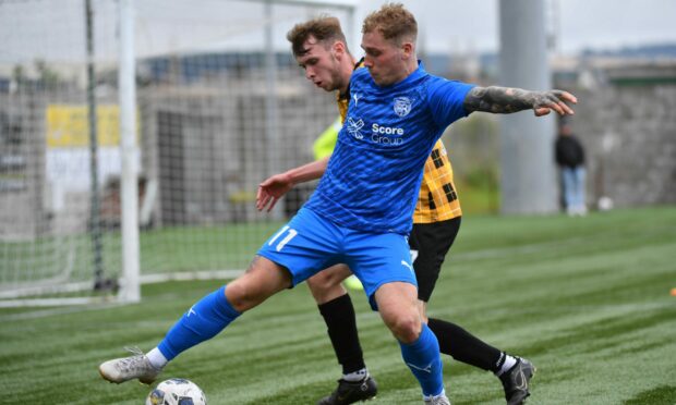 Peterhead winger Robert Ward battles with East Fife's Sean Docherty on the opening day of the League Two season.