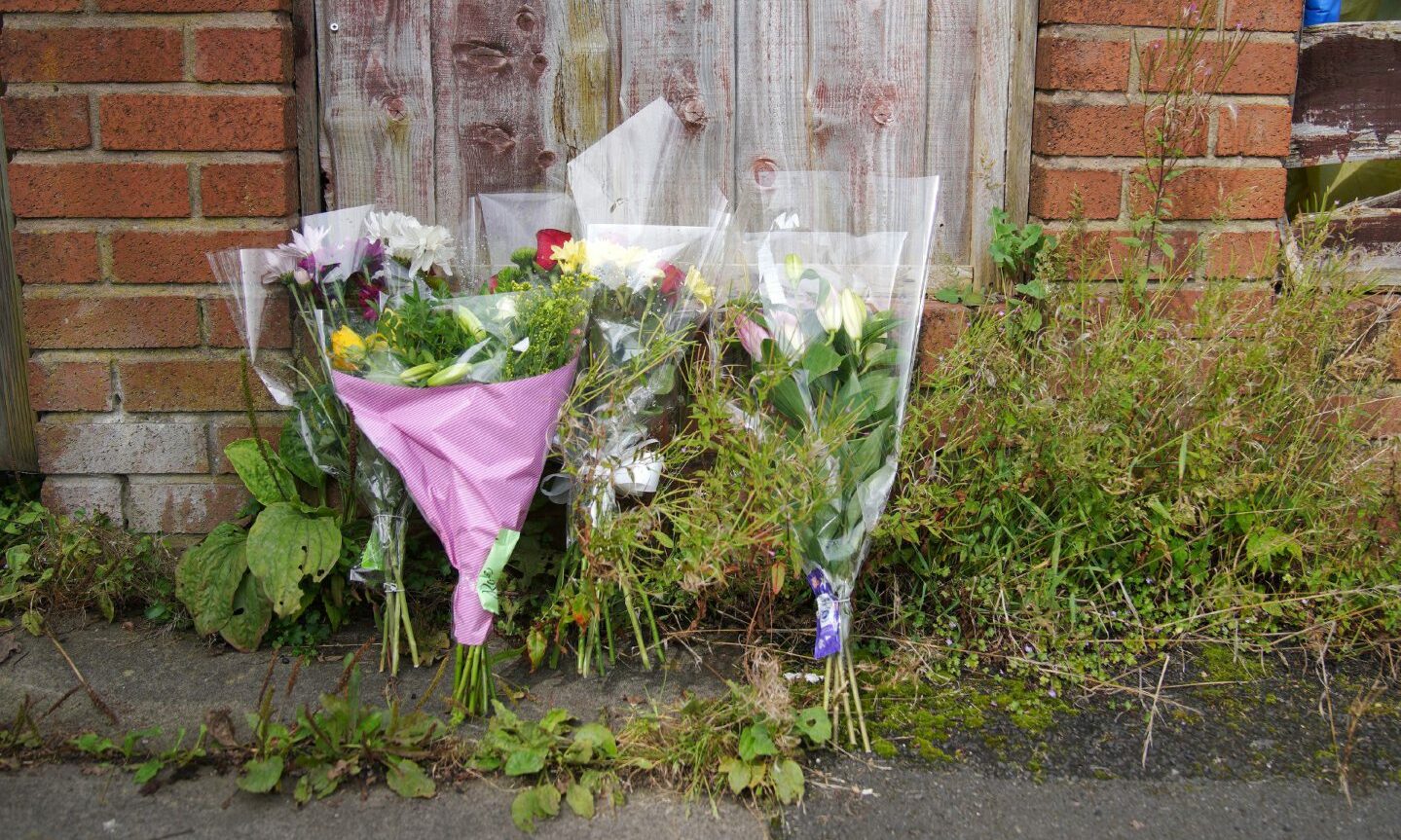 Bouquets of flowers at the scene outside Donald Patience's home. 