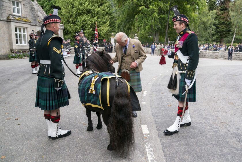 King Charles III meets the Royal Regiment of Scotland mascot Shetland pony at the gates of Balmoral.