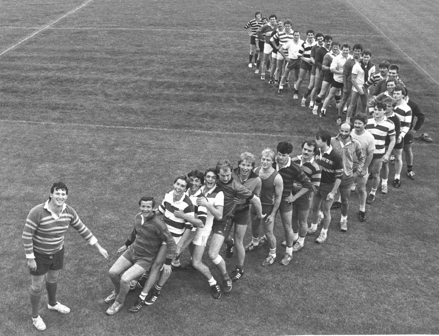 Captain of Grammar FP Rugby Club Benny Elrick, left, supervises a practice attempt at setting a human domino spill world record with club members at Rubislaw Playing Fields in 1984.