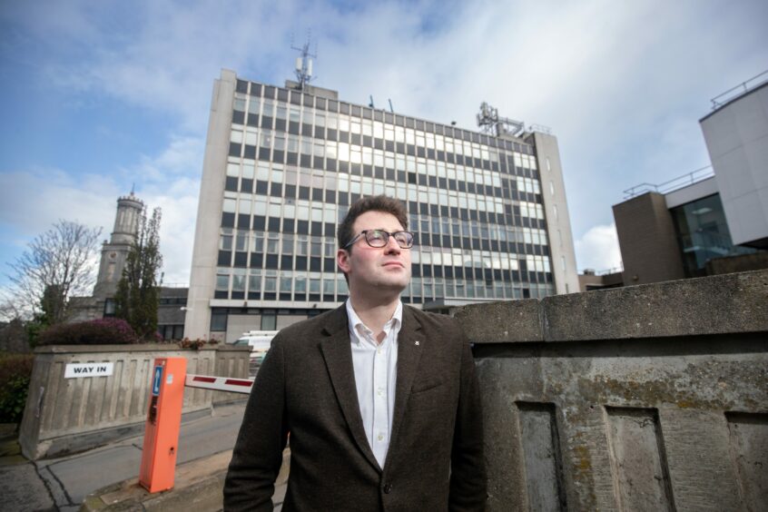 SNP council city centre spokesman Michael Hutchison in front of the former police headquarters in Queen Street. The tower could be saved as part of £61m plans for an urban park in the area. Image: Scott Baxter/DC Thomson