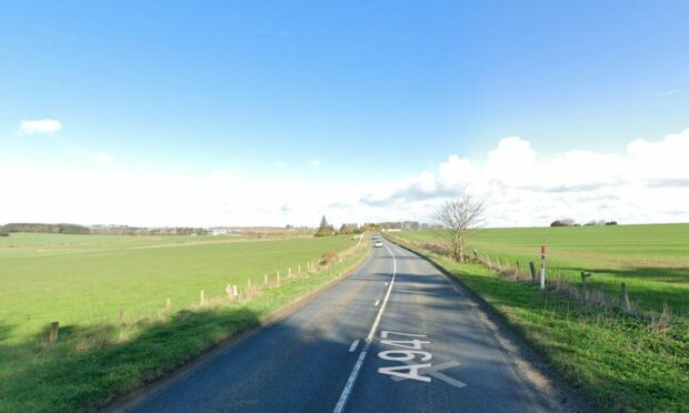 A947 Old Meldrum Road surrounded by fields.