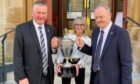 Clach chairman Alex Chisholm, Inverness provost Glynis Campbell-Sinclair, and Caley Thistle chief executive Scot Gardiner promote next week's Inverness Cup showdown outside the city's Town House.  Image: Courtesy of Caley Thistle