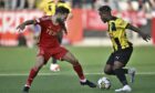 Aberdeen's Graeme Shinnie and Hacken's Ibrahim Sadiq battle for the ball during the Europa League play-off, first leg soccer match between BK Hacken and Aberdeen FC at Hisingen Arena in Gothenburg, Sweden, Thursday Aug. 24, 2023. (Bjorn Larsson Rosvall/TT via AP)