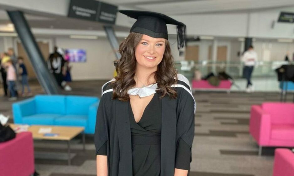 Taelor Shand pictured in her graduation cap and gown. Taylor has been denied fertility treatment despite being born without a womb.