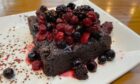 The brownie dessert with raspberries and blackberries on top