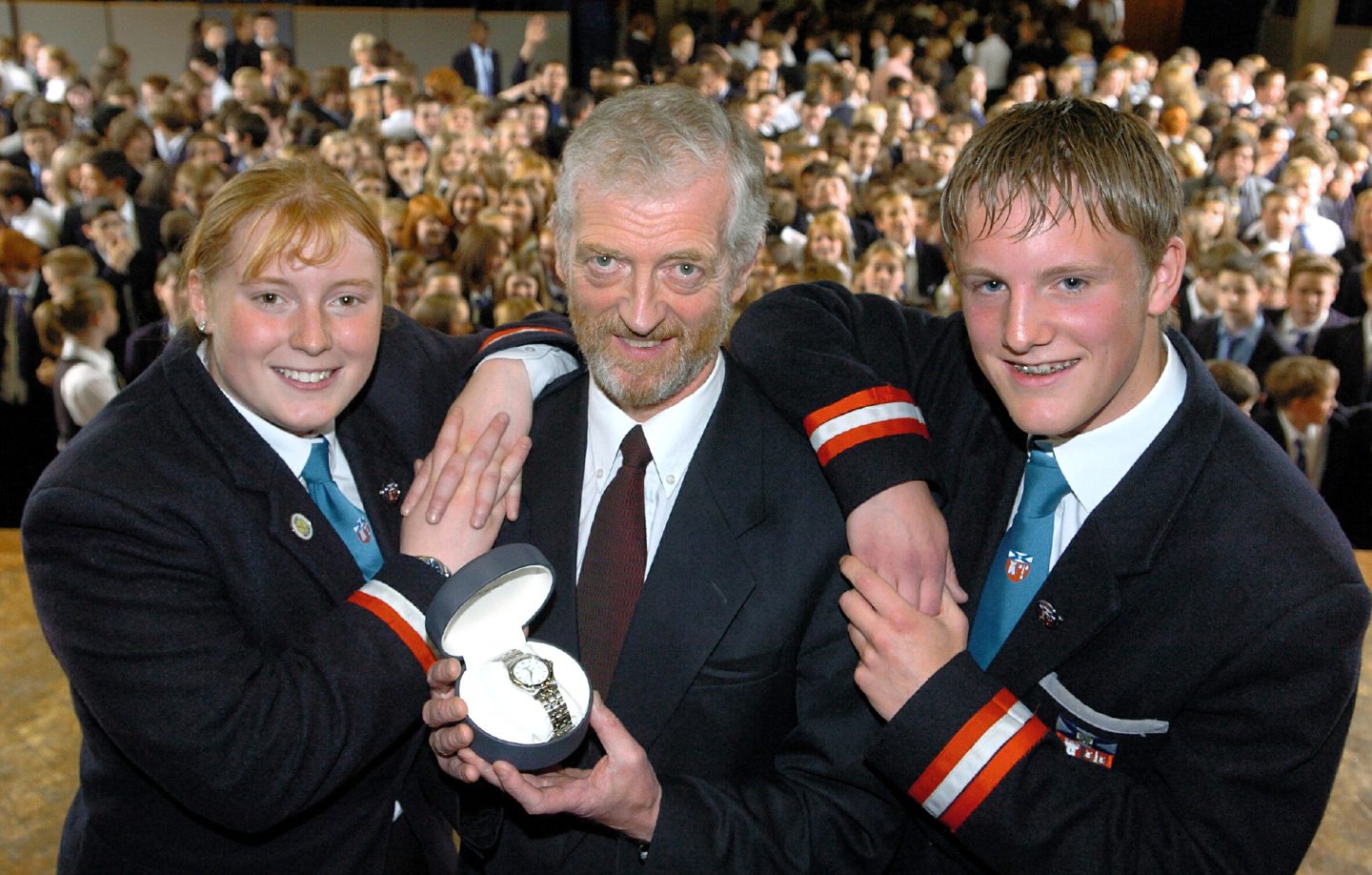  Retiring Rector of Aberdeen Grammar School Bill Johnston with a watch which was a gift from the pupils, pictured with head boy Peter Cross and deputy head girl Fiona Taylor in 2004.