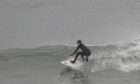 Girl surfing in sea.