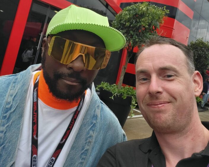 Nevis Radio presenter Simon Abberley with will.i.am of the Black Eyed Peas at the Silverstone Grand Prix