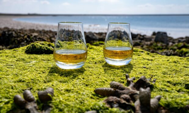 Two glasses of whisky by the sea.