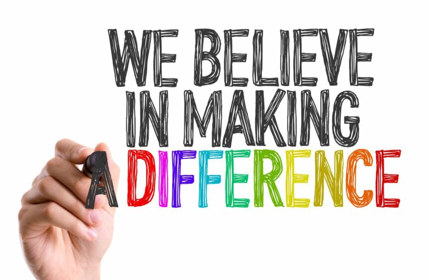 Hand with marker writing: We Believe in Making a Difference.