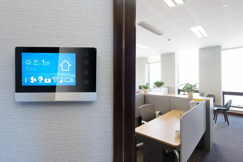 A smart screen on a wall in a modern office.