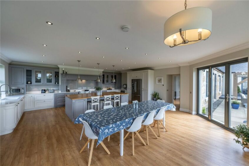 Open-plan kitchen and dining area in the farmhouse for sale in Aberdeenshire.