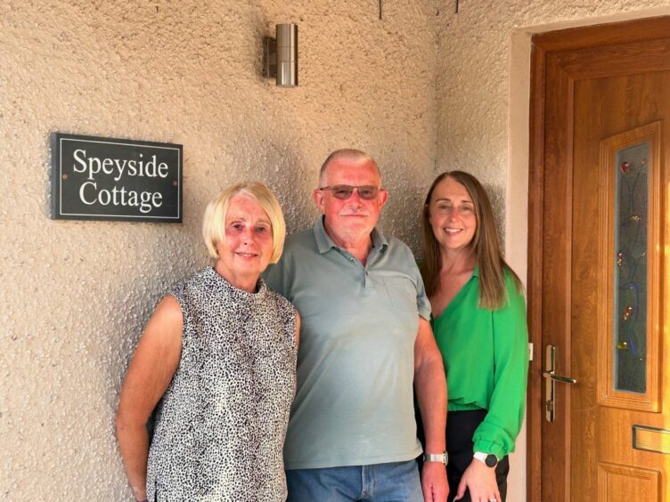 Tracey and her parents Beryl and David outside Speyside Cottage.
