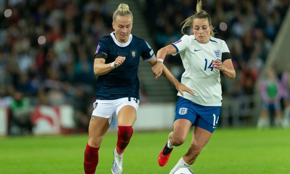 Scotland's Rachel McLauchlan battles with England's Ella Toone at the Stadium of Light.