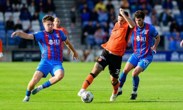 Nikola Ujdur, right, chases Dundee United's Tony Watt, while Morgan Boyes goes in to challenge. Image: Shutterstock