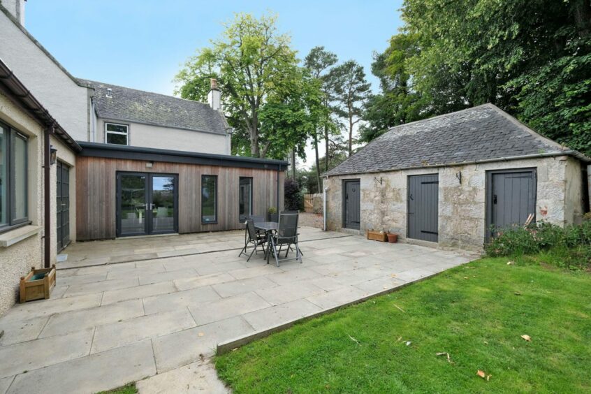 The paved portion of the garden, with an outdoor dining set.