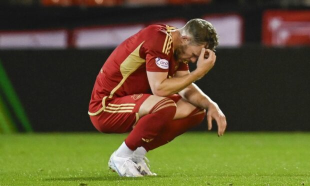 Aberdeen's Nicky Devlin looks dejected at full-time after losing 3-1 to BK Hacken. Image: SNS