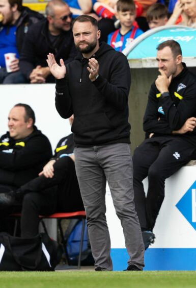James McPake clapping at the side of the pitch