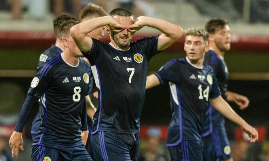 John McGinn celebrates with the rest of the Scotland national team